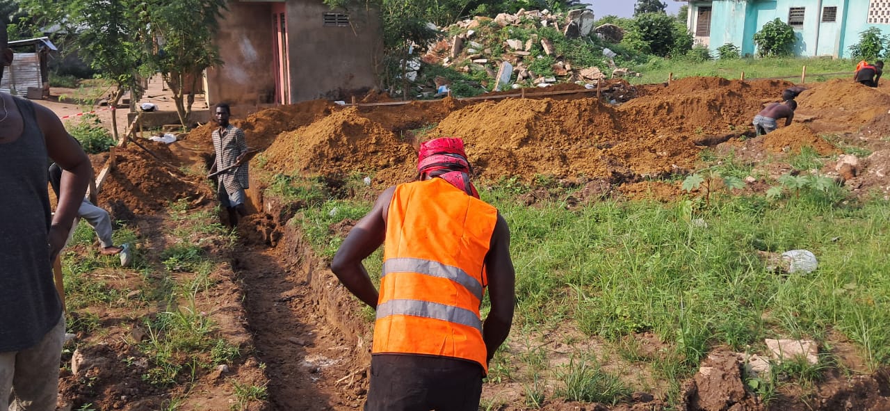 Workers excavating foundation trenches on site at the Aiyinasi District Police Headquarters construction